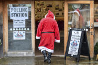 A man dressed as Father Christmas enters his grotto at the Dunster Tithe Barn near Minehead, Somerset, England which is being used as a polling station in the 2019 general election, Thursday Dec. 12, 2019. U.K. voters were deciding Thursday who they want to resolve the stalemate over Brexit in a parliamentary election seen as one of the most important since the end of World War II. (Ben Birchall/PA via AP)