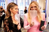 <p>Maren Morris and Miranda Lambert pose with their portable face shields at the 54th Annual CMA Awards at Music City Center in Nashville on Wednesday.</p>