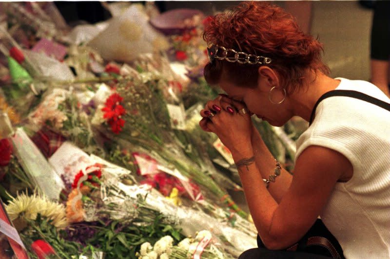 A mourner says a prayer for the late Princess Diana at a make shift floral memorial outside of the British Consulate, September 1, 1997, in New York City. Diana was laid to rest September 6, 1997. File Photo by Ezio Petersen/UPI