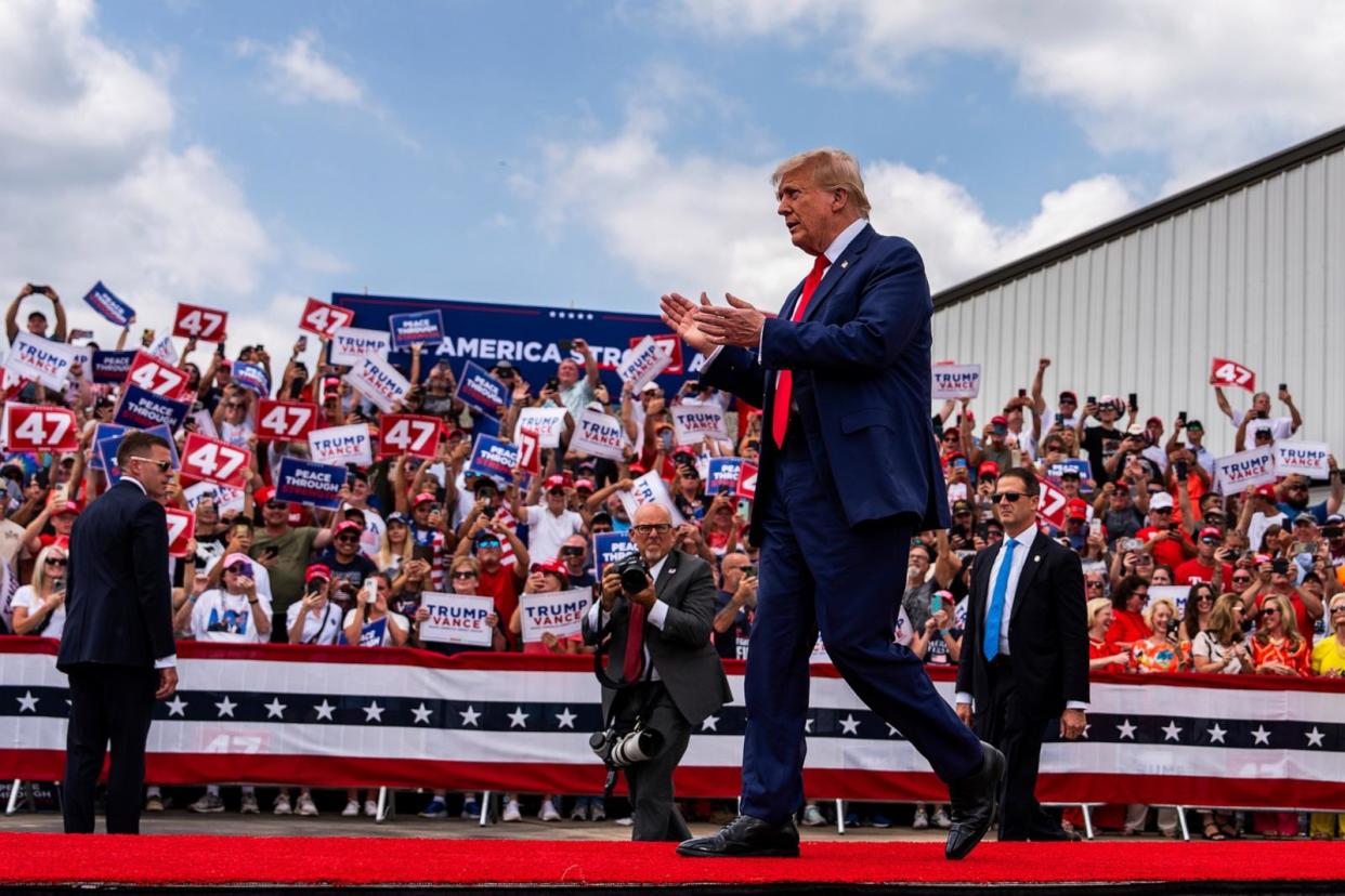 PHOTO: Republican presidential nominee former President Donald Trump walks on stage during a campaign rally at North Carolina Aviation Museum, Aug. 21, 2024, in Asheboro, N.C. (Julia Nikhinson/AP)