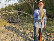 Jack Dwyer stands on the dry creek bed of Deer Creek in Selma, Ore. on Thursday, Sept. 2, 2021. In 1972, Dwyer pursued a dream of getting back to the land by moving to an idyllic, tree-studded parcel in Oregon with Deer Creek running through it. But now, Deer Creek has become a dry creek bed after several illegal marijuana grows cropped up in the neighborhood last spring, stealing water from both the stream and aquifers and throwing Dwyer's future in doubt. (Carol Valentine via AP)