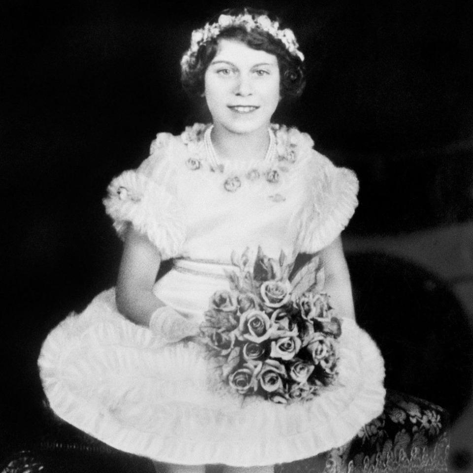 <p>The young princess poses with a bunch of flowers (PA Archive) </p>