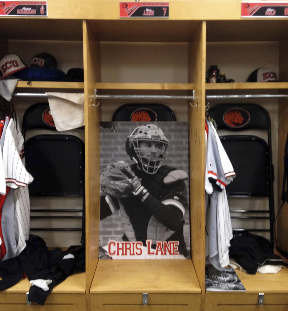 In this April 10, 2014 photo, baseball player Chris Lane’s locker is seen at East Central University in Ada, Okla. Twenty-two-year Lane, of Melbourne, Australia, was preparing to enter his senior season at East Central University when he was gunned down last August. Lane’s death has left a void for his college team. (AP Photo/Kristi Eaton)