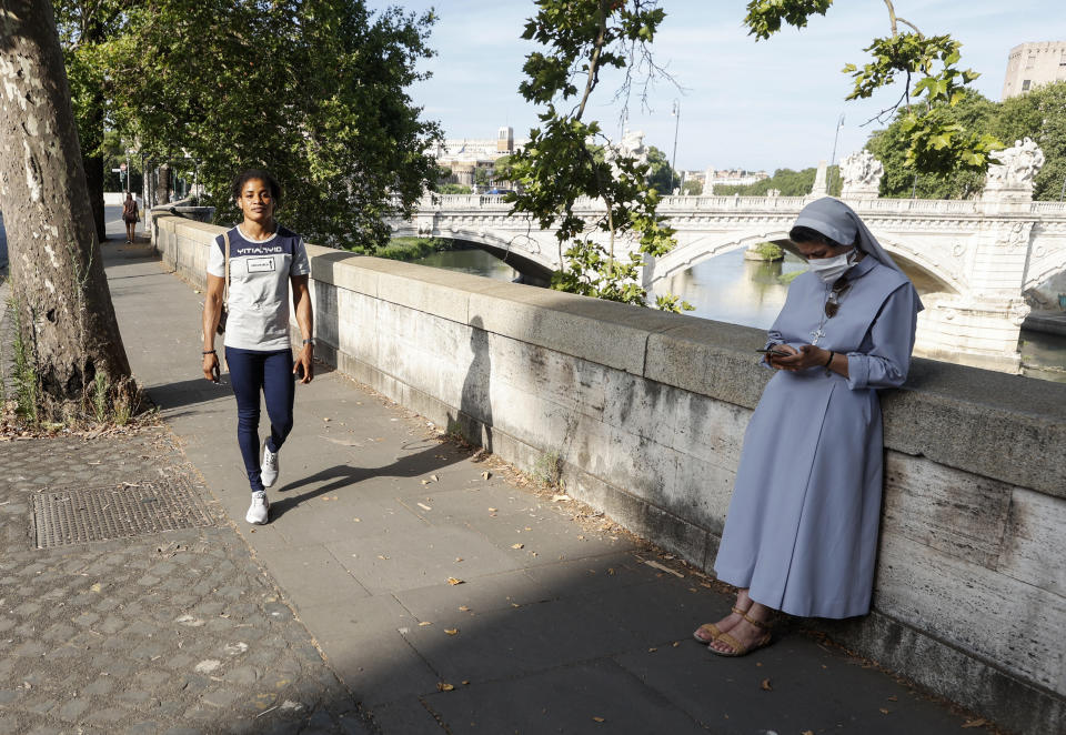 Freestyle wrestler Fatoumata Yarie Camara, of Guinea, walks in Rome, Italy, where she is training Saturday, July 3, 2021. A West African wrestler's dream of competing in the Olympics has come down to a plane ticket. Fatoumata Yarie Camara is the only Guinean athlete to qualify for these Games. She was ready for Tokyo, but confusion over travel reigned for weeks. The 25-year-old and her family can't afford it. Guinean officials promised a ticket, but at the last minute announced a withdrawal from the Olympics over COVID-19 concerns. Under international pressure, Guinea reversed its decision. (AP Photo/Riccardo De Luca)