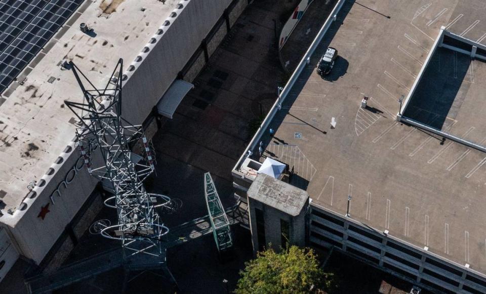 A pop-up tent stands Tuesday were a man who barricaded himself atop a downtown Sacramento parking garage was fatally shot by police during a standoff. The incident began just after 1 a.m. when the man was reported in the Downtown Plaza West parking garage at Third and L streets with a weapon.