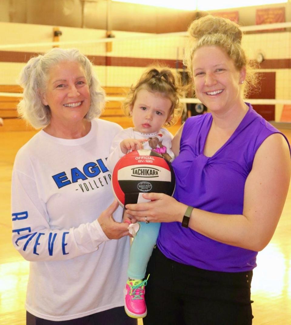 Former Worcester Tech girls' volleyball coach Sheila Marshall, left, now an assistant coach to her daughter, Doherty girls' volleyball coach Kathryn Coporale. Coporale’s daughter Ana is in the middle.