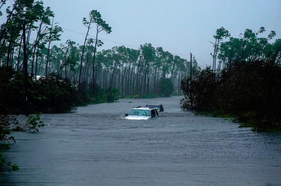 Submerged car sit submerged in water from Hurricane Dorian in Freeport, Bahamas on Sept. 3, 2019. Dorian is beginning to inch northwestward after being stationary over the Bahamas, where its relentless winds have caused catastrophic damage and flooding.