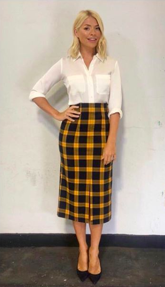 <p>In case you didn’t already notice, checks are everywhere RN. Holly demonstrated how to tackle the trend in a Topshop skirt on 4 September (which has since sold out). She finished the look with a white shirt by Winser London and LK Bennett shoes. <em>[Photo: Instagram]</em> </p>