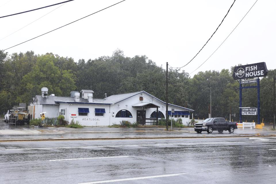 A man carries a salvageable item from the former Beach Road Fish House & Chicken Dinners to a truck on Thursday, Oct. 12, 2023, before the building's pending demolition.