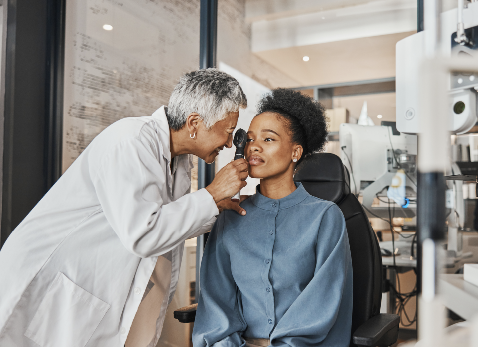 Optometrist conducting an eye examination on a patient in a clinic