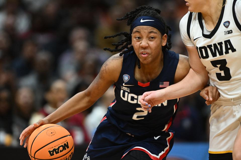Apr 5, 2024; Cleveland, OH, USA; Connecticut Huskies guard KK Arnold (2) dribbles the ball against Iowa Hawkeyes guard Sydney Affolter (3) in the semifinals of the Final Four of the womens 2024 NCAA Tournament at Rocket Mortgage FieldHouse. Mandatory Credit: Ken Blaze-USA TODAY Sports