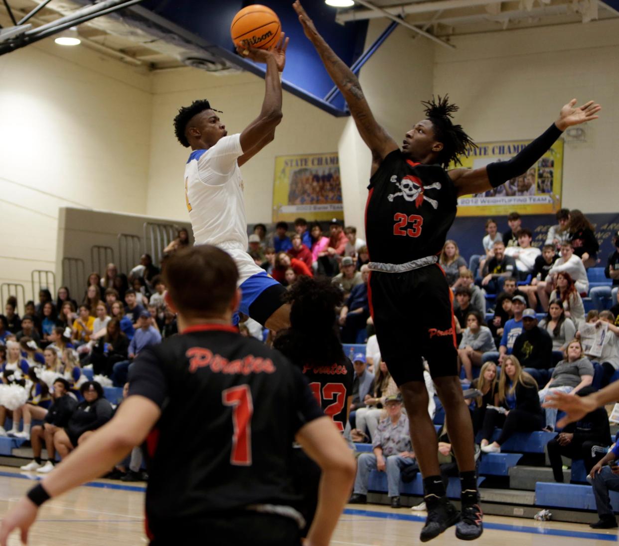 Port Charlotte High's Alex Perry goes up for a block against Charlotte High's John Gamble in the final game of the Wally Keller Classic on Saturday at Charlotte High School.