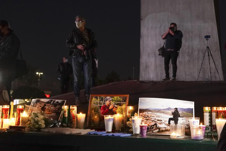 Journalists cover a vigil in honor of news photographer Margarito Martinez, Friday, Jan. 21, 2022, in Tijuana, Mexico. Martinez, a Tijuana-based photojournalist who specialized in covering crime scenes in this border city, was shot as he left his home on Jan 17. (AP Photo/Gregory Bull