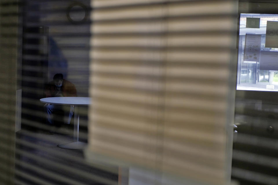 A patient sits on a chair at the Rouvray psychiatric hospital, in Rouen, western France, Wednesday, Nov. 25, 2020. Lockdowns that France has used to fight the coronavirus have come at considerable cost to mental health. Surveying points to a surge of depression most acute among people without work, in financial hardship and young adults. (AP Photo/Thibault Camus)