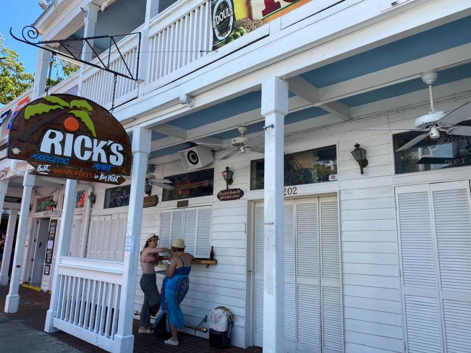 Rick’s Bar on Duval Street was closed March 18, 2020, along with all bars and clubs in Florida, per the governor’s orders. Two women use the outside as a dining table since the city of Key West also shut down on-site dining.