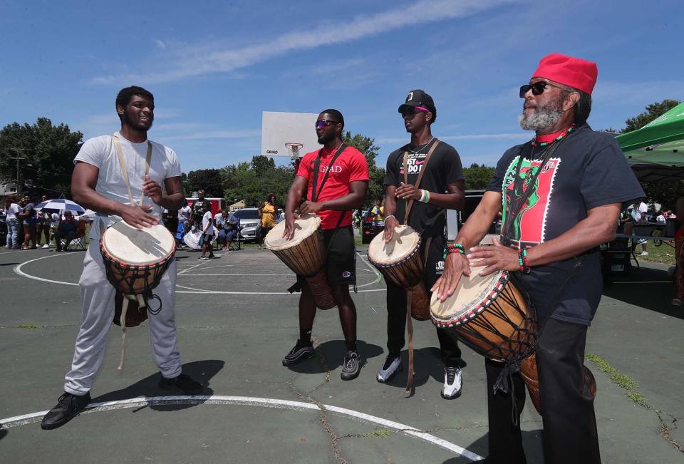 Kwame Williams, right, leads a drum circle at the 24th Annual Akron Juneteenth Festival at Stoner-Hawkins Park on Sunday in Akron.