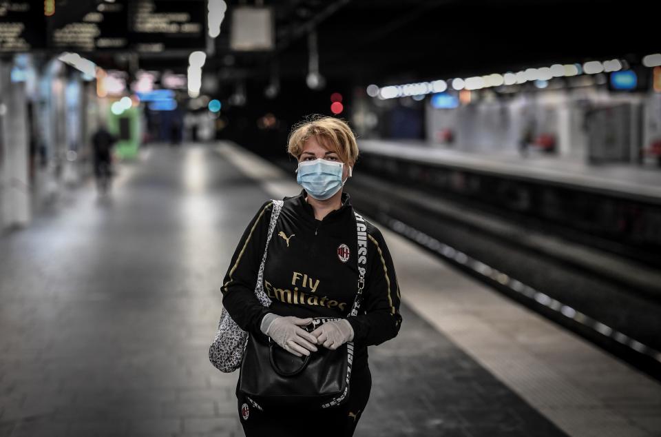 A commuter wearing a protective facemask and gloves waits on the deserted platform at the Auber metro station in Paris on April 9, 2020, on the twenty-fourth day of a lockdown in France to attempt to halt the spread of the novel coronavirus COVID-19. (Photo by STEPHANE DE SAKUTIN / AFP) (Photo by STEPHANE DE SAKUTIN/AFP via Getty Images)