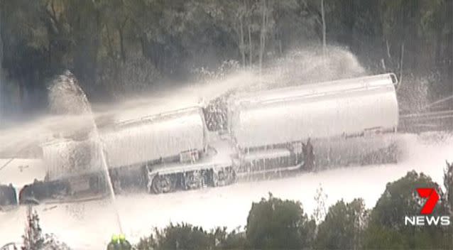 Firefighters worked to douse the flaming truck. Source: 7 News