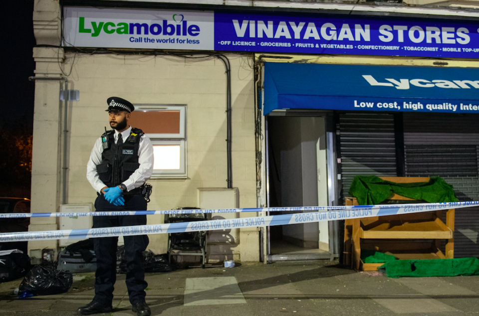 Police attending the scene of the stabbing in Aldborough Road North, Ilford. (PA)