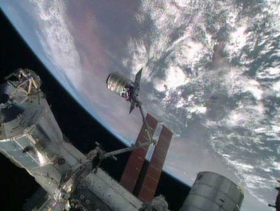 An Orbital Sciences-built Cygnus spacecraft is captured by a robotic arm on the International Space Station during docking activities on July 16, 2014. The unmanned Cygnus spacecraft delivered more than 1.5 tons of supplies to the station for N