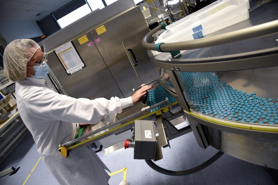 An employee works on a production line at the factory of British multinational pharmaceutical company GlaxoSmithKline (GSK) in Saint-Amand-les-Eaux, northern France, on December 3, 2020, where the adjuvant for Covid-19 vaccines will be manufactured. - Canada's Medicago and British pharmaceutical giant GlaxoSmithKline (GSK) announced on December 3, 2020 the launch of phase 2 and 3 clinical trials on a Covid-19 vaccine, one of a series of candidates being developed worldwide. Final phase 3 trials of the plant-derived vaccine candidate will begin by year's end and will be tested on 30,000 volunteers in North America, Latin America and Europe, according to a joint statement. (Photo by FRANCOIS LO PRESTI / AFP) (Photo by FRANCOIS LO PRESTI/AFP via Getty Images)