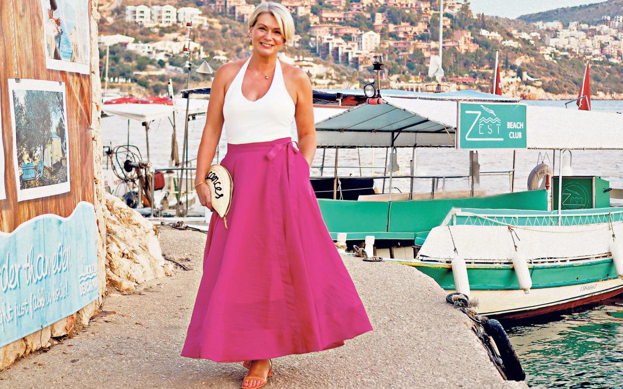 Sunshine dressing: Nikki Garnett shines in a hot pink skirt and halterneck on holiday - Courtesy of Nikki Garnett