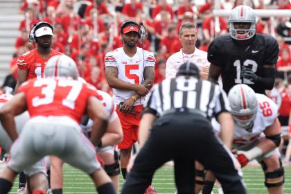 Quarterbacks J.T. Barrett (16) and Braxton Miller (5) watch alongside Ohio State's Urban Meyer during spring practice. (Getty)