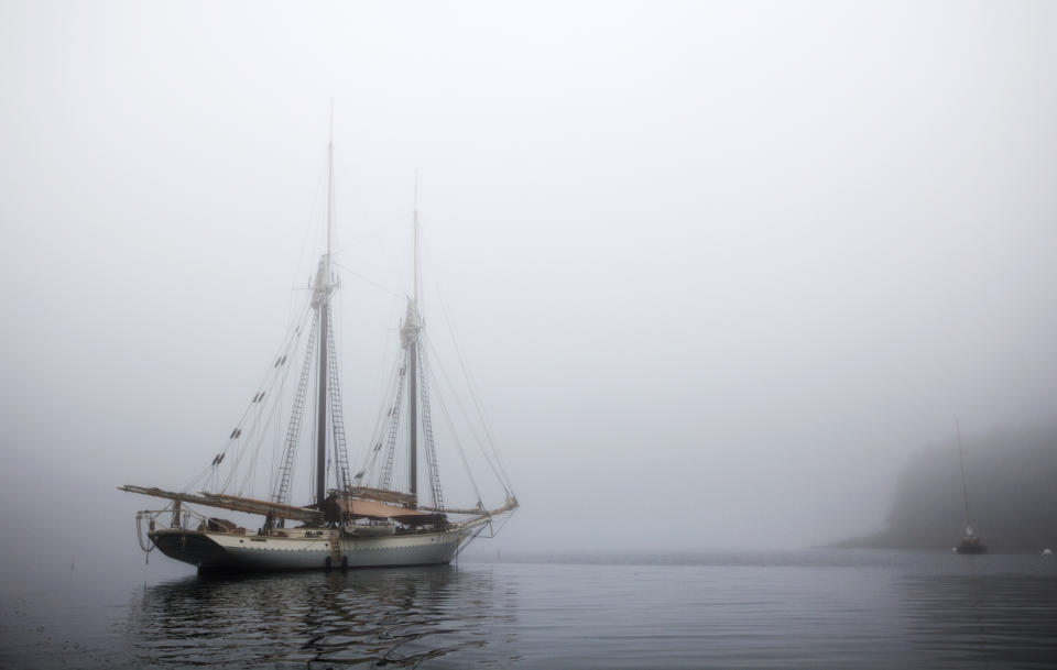 In this photo made Friday, Aug. 3, 2012, the schooner Mary Day sits at anchor in the morning fog off South Brooksville, Maine. The 90-foot Mary Day, which is celebrating its 50th season, is the first schooner in the Maine windjammer fleet to be built specifically to accommodate passengers. Its sleeping cabins are heated and have nine feet of headroom. (AP Photo/Robert F. Bukaty)