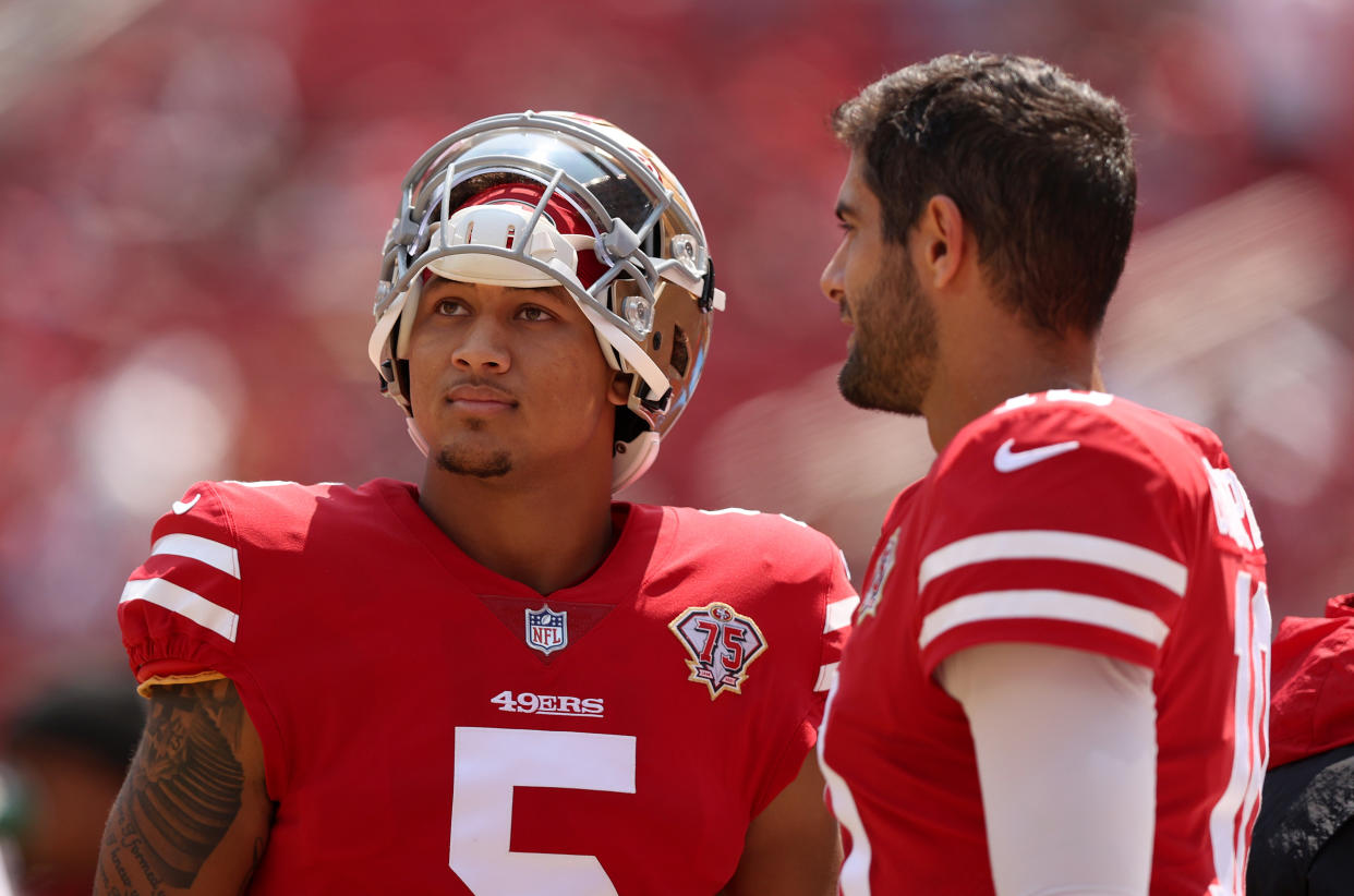 Jimmy Garoppolo #10 and Trey Lance #5 of the San Francisco 49ers 