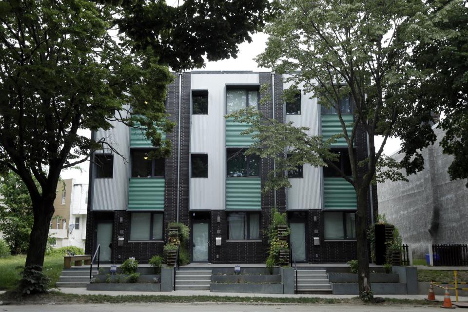 This June 6, 2013 photo shows passive homes in Philadelphia. These homes are built around the idea that houses can be airtight, super-insulated and energy efficient. The goal: a house that creates nearly as much energy as it consumes. (AP Photo/Matt Rourke)