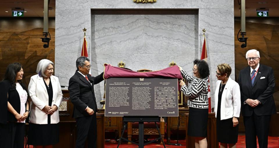 A commemorative plaque is unveiled during the National Remembrance Ceremony for the 100th Anniversary of the Chinese Exclusion Act, in the Senate Chamber in Ottawa on June 23, 2023. THE CANADIAN PRESS/Justin Tang