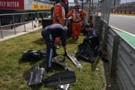 Debris from broken cars is collected during the British Formula One Grand Prix at the Silverstone circuit, in Silverstone, England, Sunday, July 3, 2022. (AP Photo/Matt Dunham, Pool)