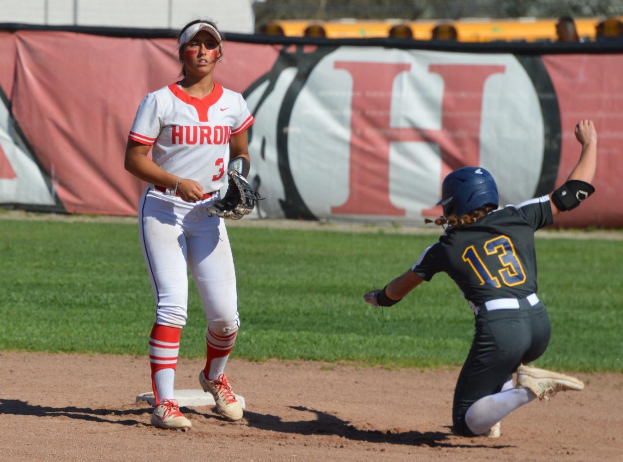 Airport’s Olivia Tilley slides into second base as New Boston Huron’s Erin Newman waits for the throw during a 7-6 Airport win on Monday, April 15, 2024.