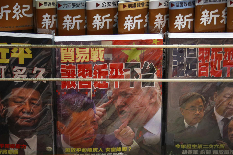 FILE - In this July 4, 2019, file photo, magazines with a front cover featuring Chinese President Xi Jinping and U.S. President Donald Trump on trade war is placed on sale at a roadside bookstand in Hong Kong. China has announced some U.S. industrial chemicals will be exempt from tariff hikes imposed in a trade war with Washington but maintained penalties on soybeans, pork and other farm goods. The Ministry of Finance's announcement Wednesday, Sept. 11, 2019 came ahead of October talks aimed at ending the fight over trade and technology that threatens global economic growth. (AP Photo/Andy Wong, File)