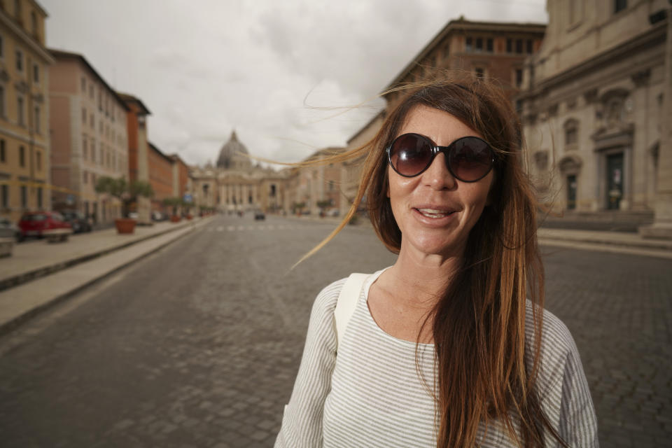 Artist Alessia Babrow poses for photos during an interview with the Associated Press, at the Vatican, Friday, May 14, 2021. Babrow sued the Vatican City State’s telecommunications office in a Rome court last month, saying it was wrongfully profiting off her creativity and violating the original intent of her artwork. The lawsuit, which is seeking nearly 130,000 euro in damages, said the Vatican had ignored Babrow’s attempts to negotiate a settlement after she discovered it had reproduced her poster art unlawfully. (AP Photo/Andrew Medichini)