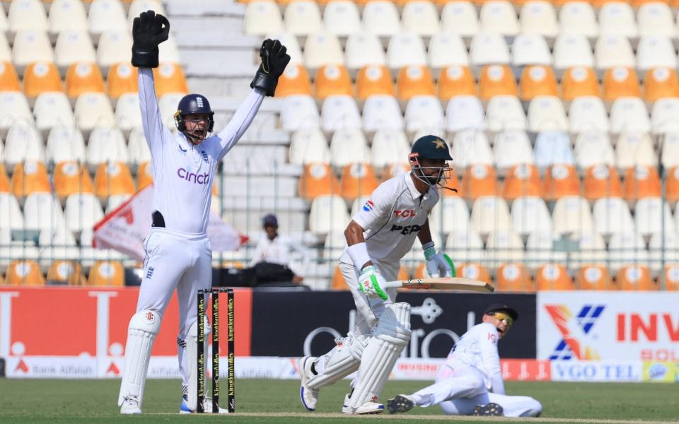 England's Jamie Smith reacts as Pakistan's Shan Masood runs between the wickets