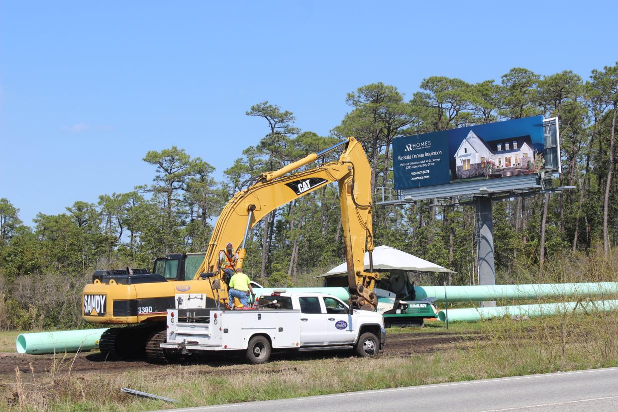 Crews work to relocate utility lines along N.C. 211 near Southport on March 30, 2023. While work continues on N.C. 211, residents wonder what other projects are planned to alleviate congestion caused by the population growth.