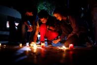 Students place candles on the ground during a silent candlelight vigil to protest against the assassination of investigative journalist Daphne Caruana Galizia in a car bomb attack two days ago, at the University of Malta in Msida, Malta, October 18, 2017. REUTERS/Darrin Zammit Lupi