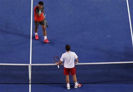 Rafael Nadal of Spain covers his face as he walks to the net to shake hands with Stanislas Wawrinka of Switzerland after losing their men's singles final match at the Australian Open 2014 tennis tournament in Melbourne January 26, 2014. REUTERS/David Gray