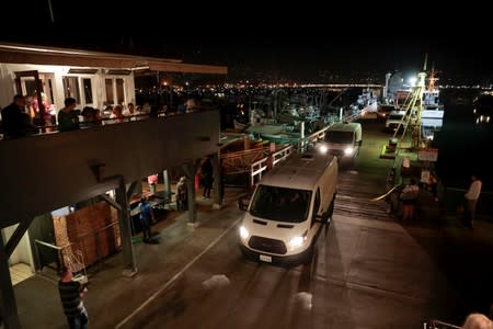 Rescue personnel return to shore with the victims of a pre-dawn fire that sank a commercial diving boat off the coast of Santa Barbara, California