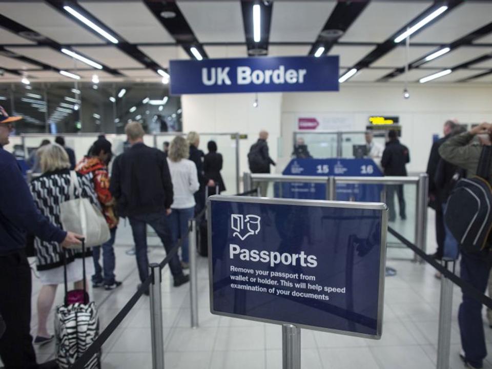 Border Force check the passports of passengers arriving at Gatwick Airport (Getty)