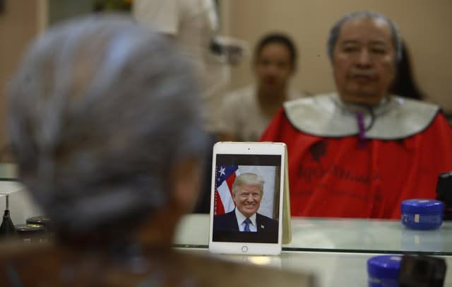 Le Phuc Hai, 66, receives a Trump haircut in Hanoi, Vietnam