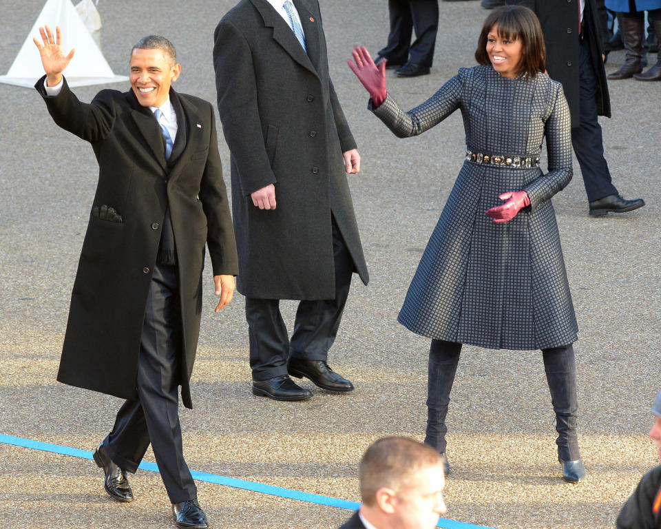 The couple waves to fans along the parade route after Obama had been inaugurated for his second term in 2013.