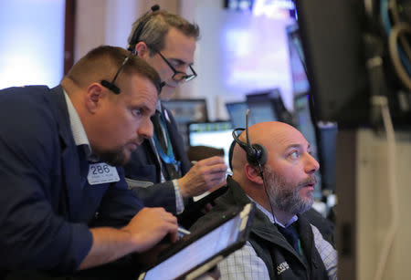 Traders work on the floor at the New York Stock Exchange (NYSE) in New York City, U.S., November 12, 2018. REUTERS/Brendan McDermid