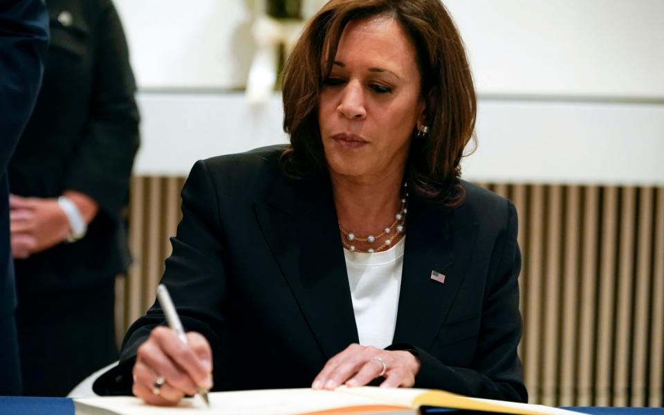 Vice President Kamala Harris signs a condolence book at the British Embassy in Washington, Friday, Sept. 9, 2022, for Queen Elizabeth II, Britain's longest-reigning monarch and a rock of stability across much of a turbulent century, who died Thursday, Sept. 8, after 70 years on the throne. She was 96 - AP