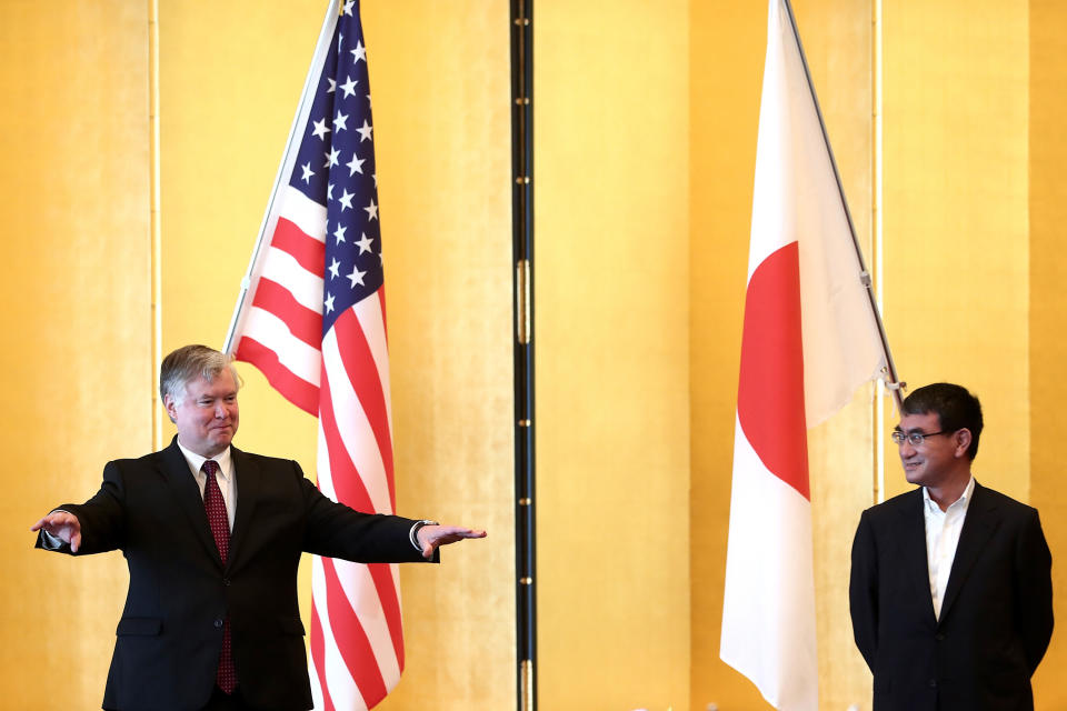 U.S. Deputy Secretary of State Stephen Biegun, left, and Japan's Defense Minister Taro Kono pose for a photo session prior to their bilateral meeting in Tokyo Friday, July 10, 2020. (Behrouz Mehri/Pool Photo via AP)