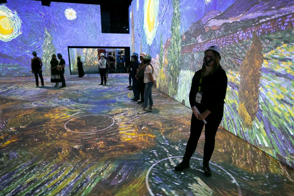 People look on during a preview tour of the Immersive Van Gogh exhibit at the Lighthouse Artspace in Scottsdale on August 17, 2021. The exhibit opens to the public on August 26, 2021.