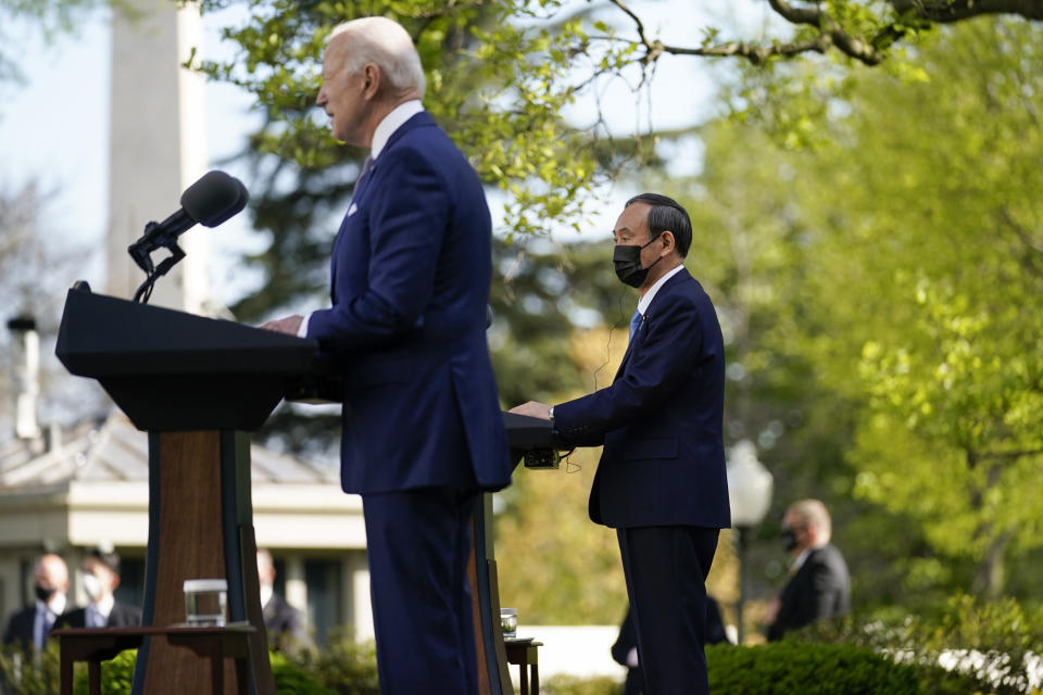 Japanese Prime Minister Yoshihide Suga, listen as President Joe Biden speaks at a news conference in the Rose Garden of the White House, Friday, April 16, 2021, in Washington. (AP Photo/Andrew Harnik)