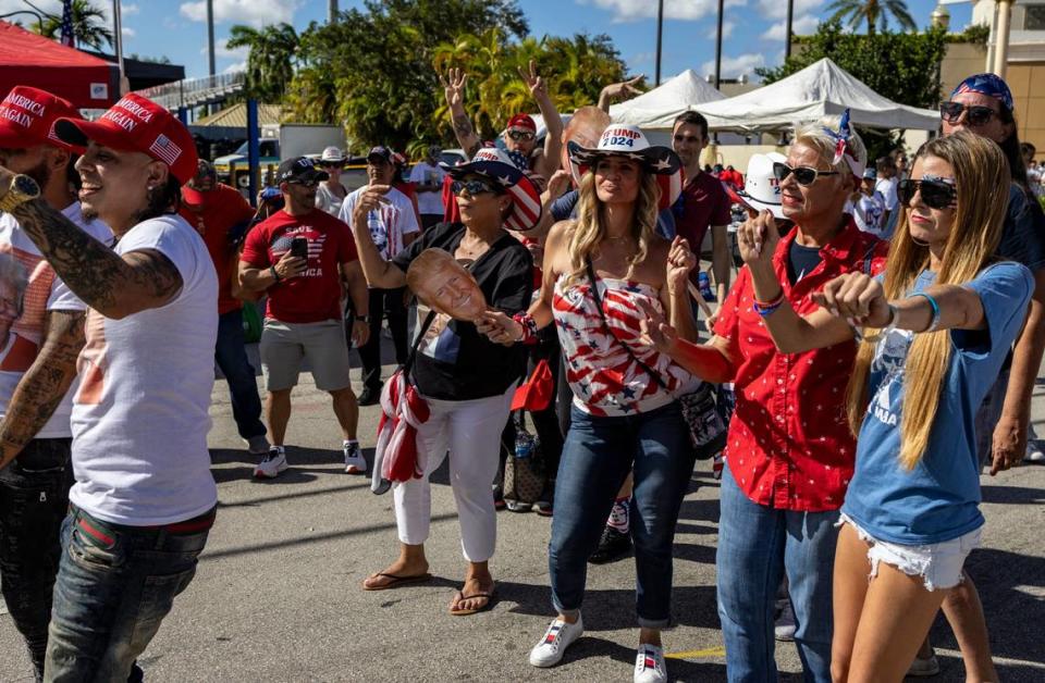 Trump supporters dance in the streets as they patiently wait in the hot sun to get into Ted Hendricks Stadium for the rally in Hialeah on Wednesday, November 8, 2023. On the night of the RNC debate in Miami, former President Donald Trump will hold a rally in Hialeah. Jose A. Iglesias/jiglesias@elnuevoherald.com