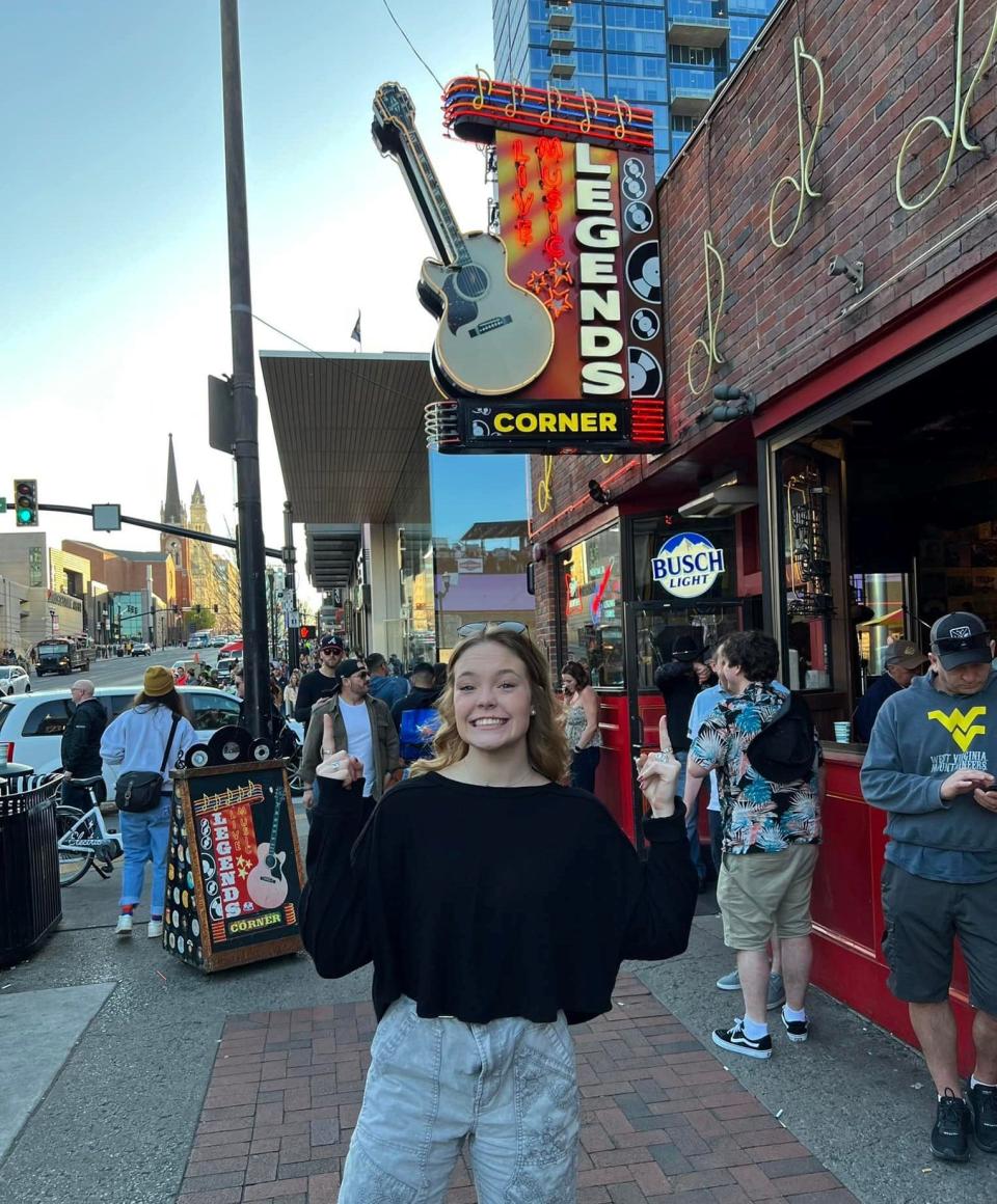 Singer-songwriter Carrie Brockwell poses for a photo in front of Legends Corner where she made her Nashville Broadway debut in April of 2022.